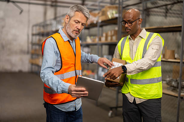 istock Two personnel are sorting boxes in the storage facility 2214835018