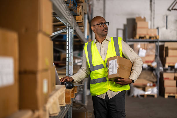 istock Latin American warehouse worker reorganizing stored boxes 2214835041