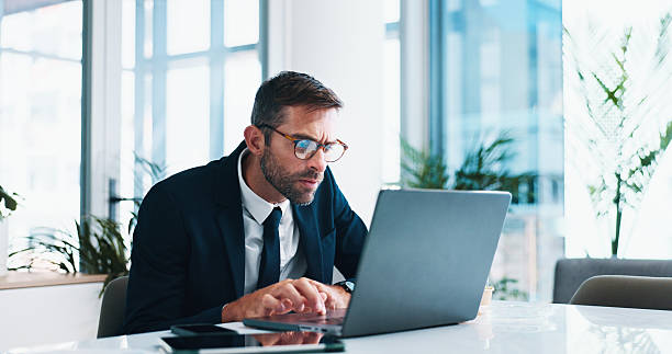 istock Man, lawyer and typing with laptop, stress and legal review with info, problem solving or update in office. Person, attorney or advocate by pc, report or thinking with lead for court case at law firm 2214836125