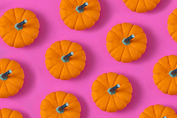 istock Pumpkins Repetition on Pink Background 2214837830