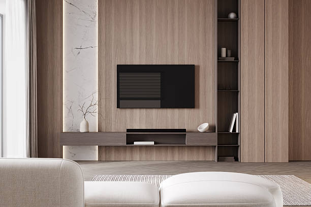 istock Blank TV screen in modern light interior with white sofa in stylish mock up, front view. TV in living room interior background, empty TV display template, 3d render 2214837991