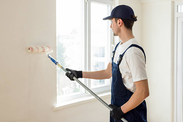 istock Young male painter painting a wall indoors 2214840387