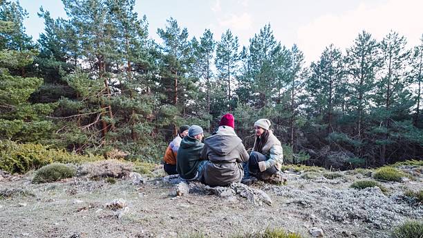 istock Hikers resting and enjoying the mountain view in winter forest 2214841667