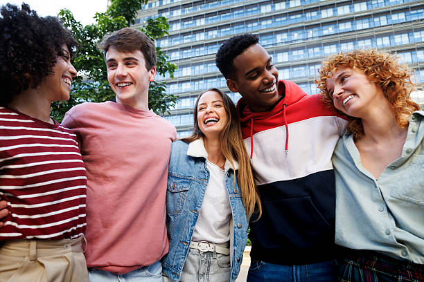 istock Happy multi-ethnic students hugging and laughing together outdoors 2214843649