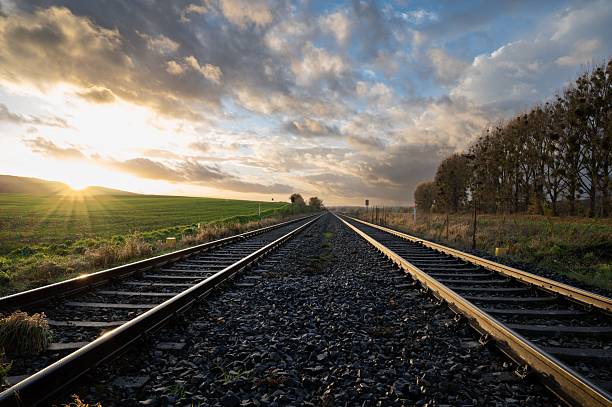 istock The sun is setting over a train track in the country 2214844357