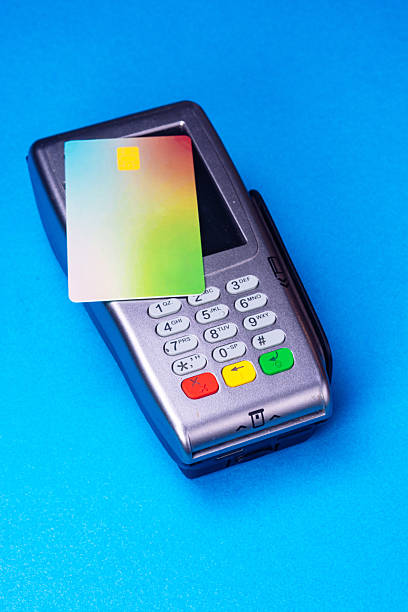 istock Credit card resting on pos terminal for contactless payment 2214844763