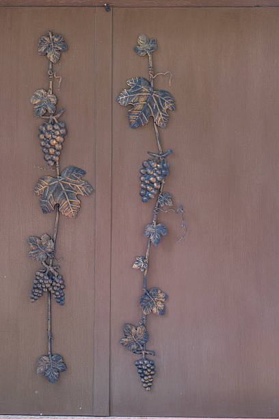 istock Decorative metal grapevines decorating wooden door 2214846055