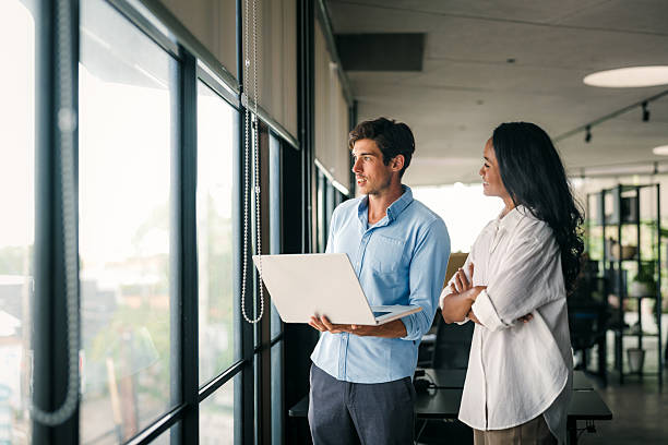 istock Group of young multi-ethnic startup business team collaborating on project in modern office 2214849658