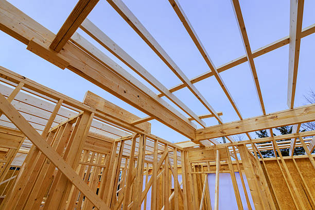 istock Construction of a wooden structure under a clear sky with framing in progress 2214850432