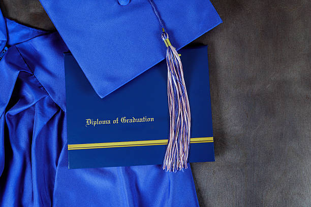 istock Graduation cap and diploma displayed on a dark background, symbolizing achievement and transition to the next chapter 2214850447