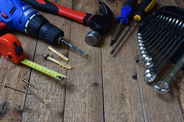 istock Set of various hand tools including drill, hammer, wrench, screwdriver, nails, screws on vintage wooden table. Concept of manual labor, hardware equipment, home renovation, construction, carpentry. 2214857325