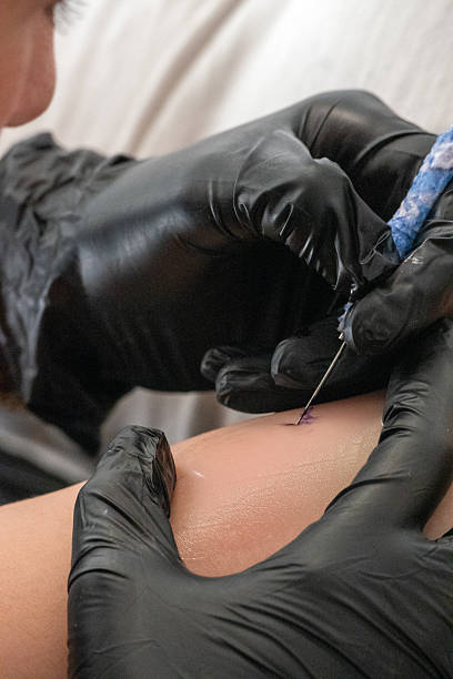 istock Tattoo Artist Begins Fine Line Work on Client’s Skin 2214860493