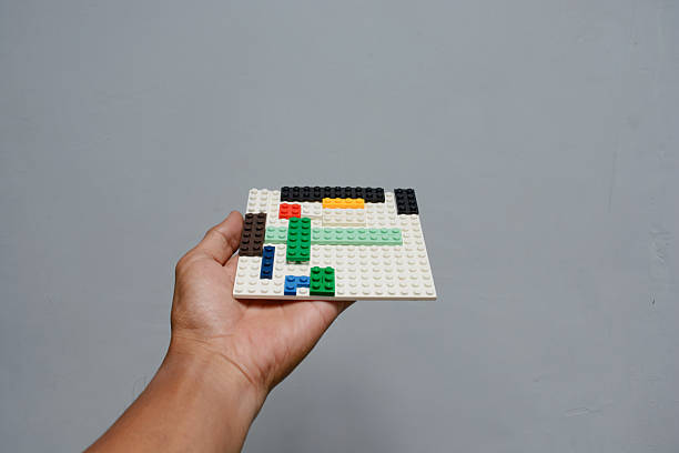 Hands holding colorful mini block toy board