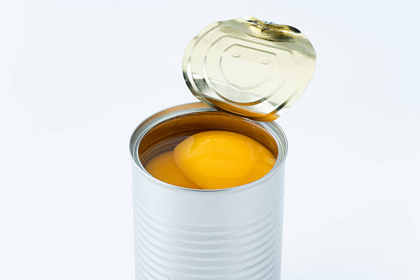 istock Canned yellow peaches against a white background 2214860714