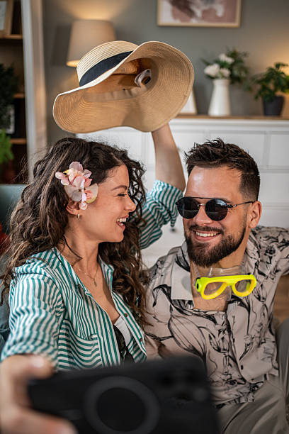 istock Young couple taking a selfie while dreaming of vacation 2214860771