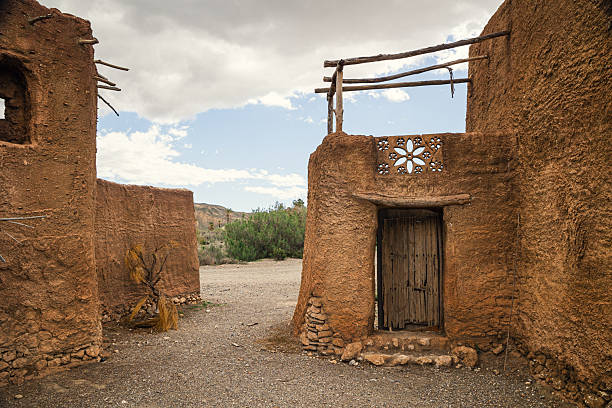 istock Front view of rustic adobe film set doorway with decorative brickwork in Tabernas Desert, Almeria, surrounded by dry terrain and sparse vegetation 2214862339