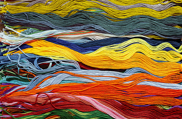 istock A solid background of colorful threads for cross stitch and needlework. Textured background for needlework and design. Rainbow of threads. Rows of colorful embroidery threads. 2214863782