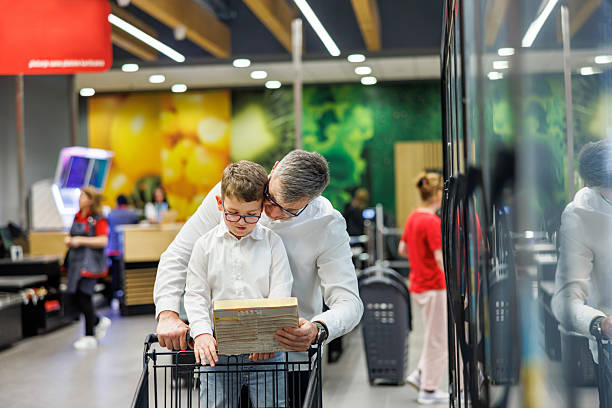 istock Father and Son Choosing Pizza in Supermarket 2214864827