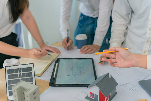 istock Business construction concept architect or engineer discussing with construction blueprint at table. Engineer inspecting workplace to plan architecture. Drafting construction project. Close up. 2214868455