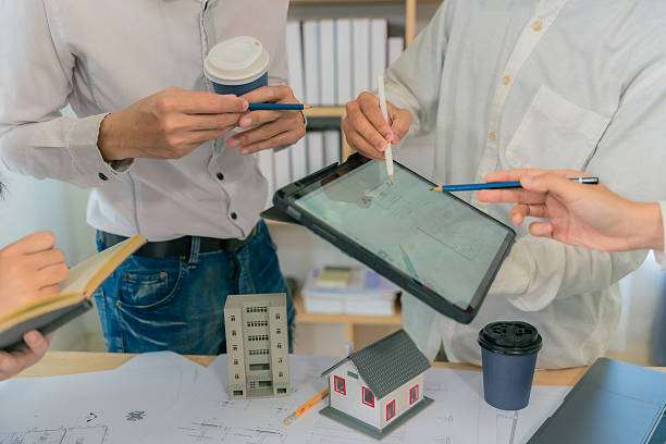 istock Business construction concept architect or engineer discussing with construction blueprint at table. Engineer inspecting workplace to plan architecture. Drafting construction project. Close up. 2214868472