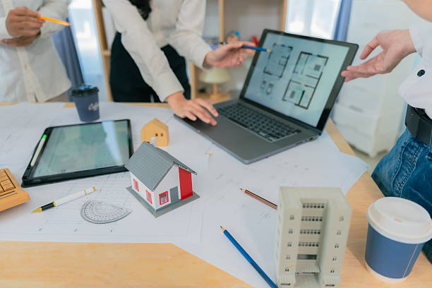 istock Business construction concept architect or engineer discussing with construction blueprint at table. Engineer inspecting workplace to plan architecture. Drafting construction project. Close up. 2214868483