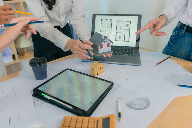 istock Business construction concept architect or engineer discussing with construction blueprint at table. Engineer inspecting workplace to plan architecture. Drafting construction project. Close up. 2214868489