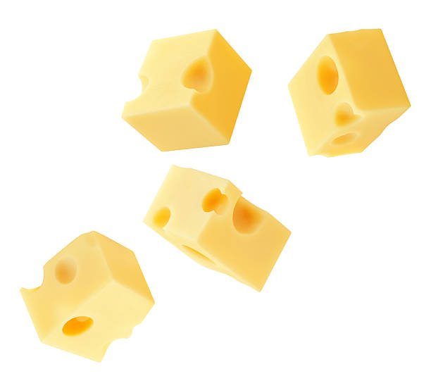 istock Flying Cheese pieces isolated on white. Levitating maasdam cheese cubes. Holey Chese Explosion. Top view. Flat lay.  Package design element.  Creative layout 2214869331