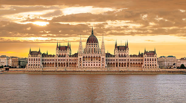 istock Hungarian parliament building reflecting on danube river at sunset 2214870061