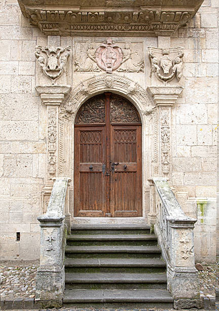 Studded, blue-green entry door of Sponza Palace with bronze lock, keyhole, and handle in Dubrovnik, Croatia, Europe