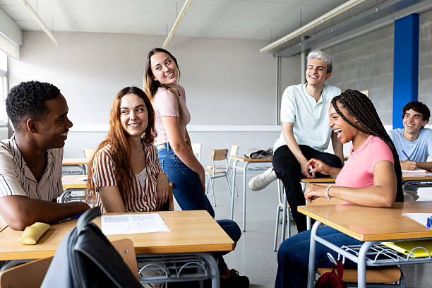 istock Cheerful high school students chatting in classroom 2214871215