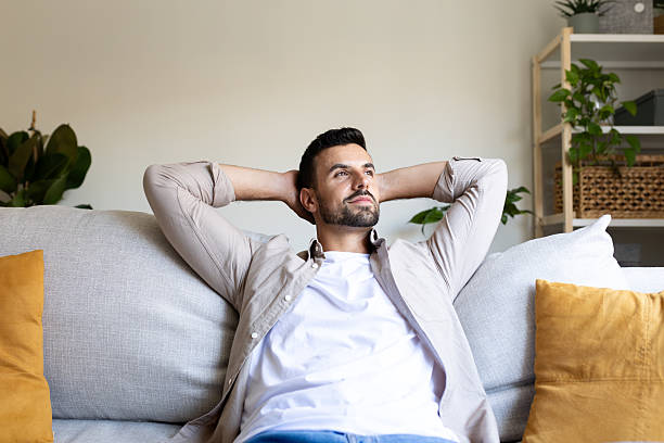 istock Serene man relaxing on sofa: finding peace at home 2214871224
