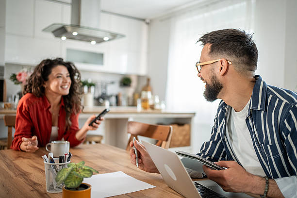 istock Couple working from home having a business meeting at kitchen table 2214872441