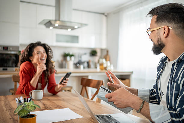 istock Couple working from home having fun while planning their day 2214872445