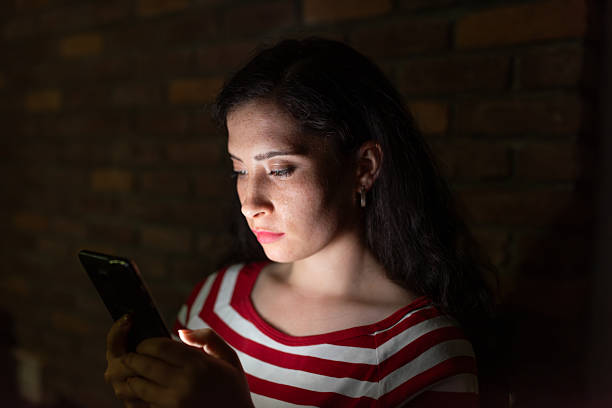 istock A young woman looking smartphone screen in the evening 2214872798