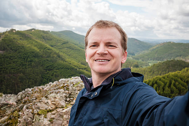 istock Hiker taking selfie on mountain top in serras do porto 2214873645
