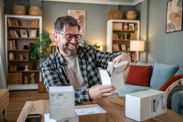istock Happy mature man unboxing multiple packages at home 2214874983