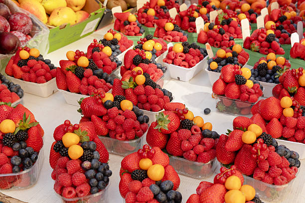 istock Assorted fresh berries and fruits in market display 2214875256