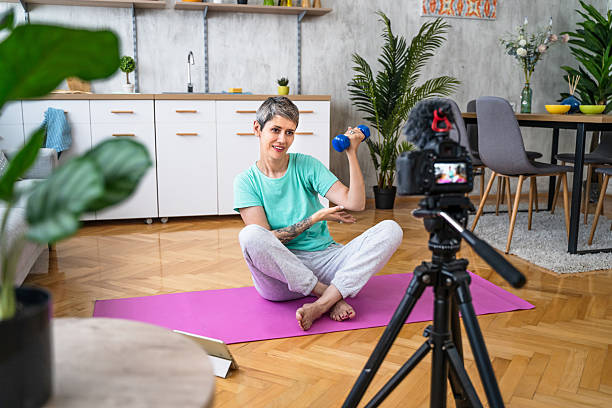 istock Fitness influencer recording workout video at home 2214878206