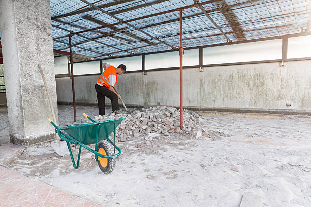 istock Home repair. Worker with orange reflective jacket and shovel 2214878396