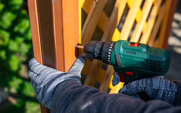 istock Screwing screws using an electric screwdriver. Assembling furniture using a cordless drill-screwdriver. Modern technologies in construction. 2214878422