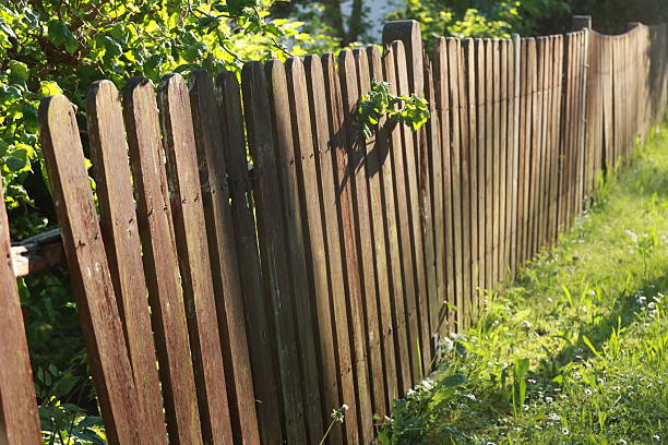 istock A wooden fence with a broken section 2214879325