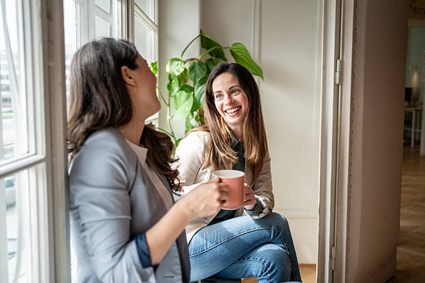 istock Two businesswomen enjoying a coffee break by the window 2214879396
