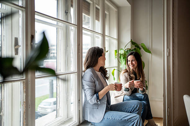 istock Two female colleagues enjoying a coffee break by the window 2214879399