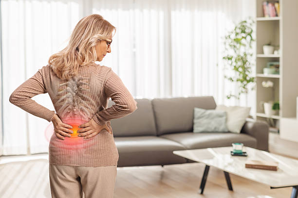 istock Middle aged woman at home with stiff spine 2214881462
