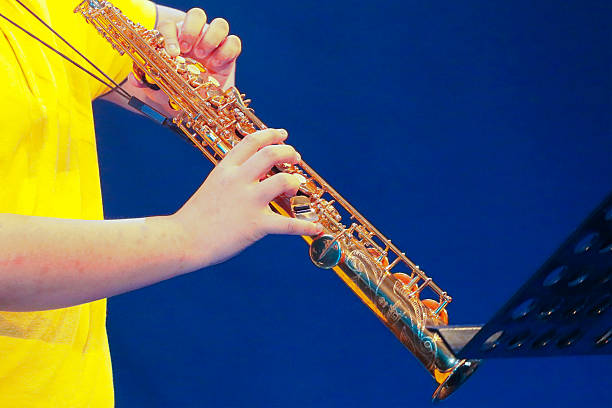 Extreme close up of an oboe player blowing his reed. Shallow depth of field with focus on the reed.
