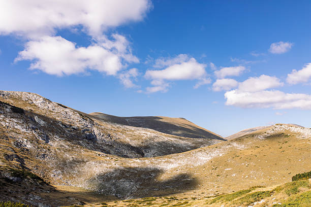 Landscape of beautiful high altitude mountains with beautiful clouds over blue sky