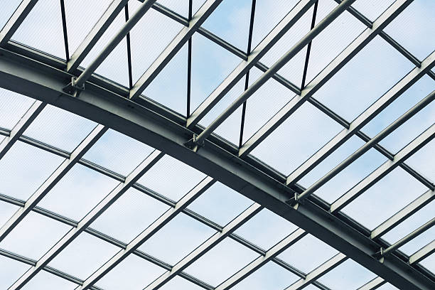 istock Modern glass roof with steel structure. Architectural ceiling in daylight. Transparent panels with grid lines. 2214888844