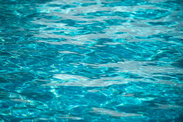 istock Ripple Water in swimming pool with sun reflection. Wavy water background. 2214888921