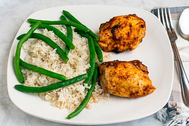 istock seasoned chicken thighs  witgh rice 2214891875