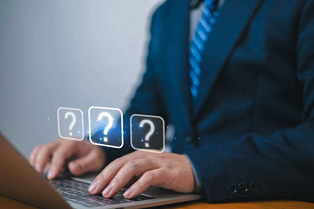 istock Question mark, Businessman showing question mark icon in front of laptop, Technology question concept, FAQ, Wondering questioning and problem-solving, Q and A, ask 2214893762